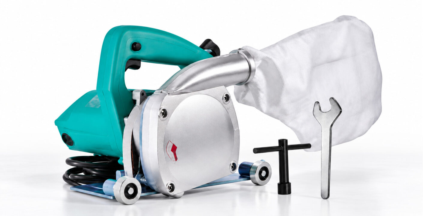 Electric floor groover with a silver blade housing, green handle, white collection bag and two tools.