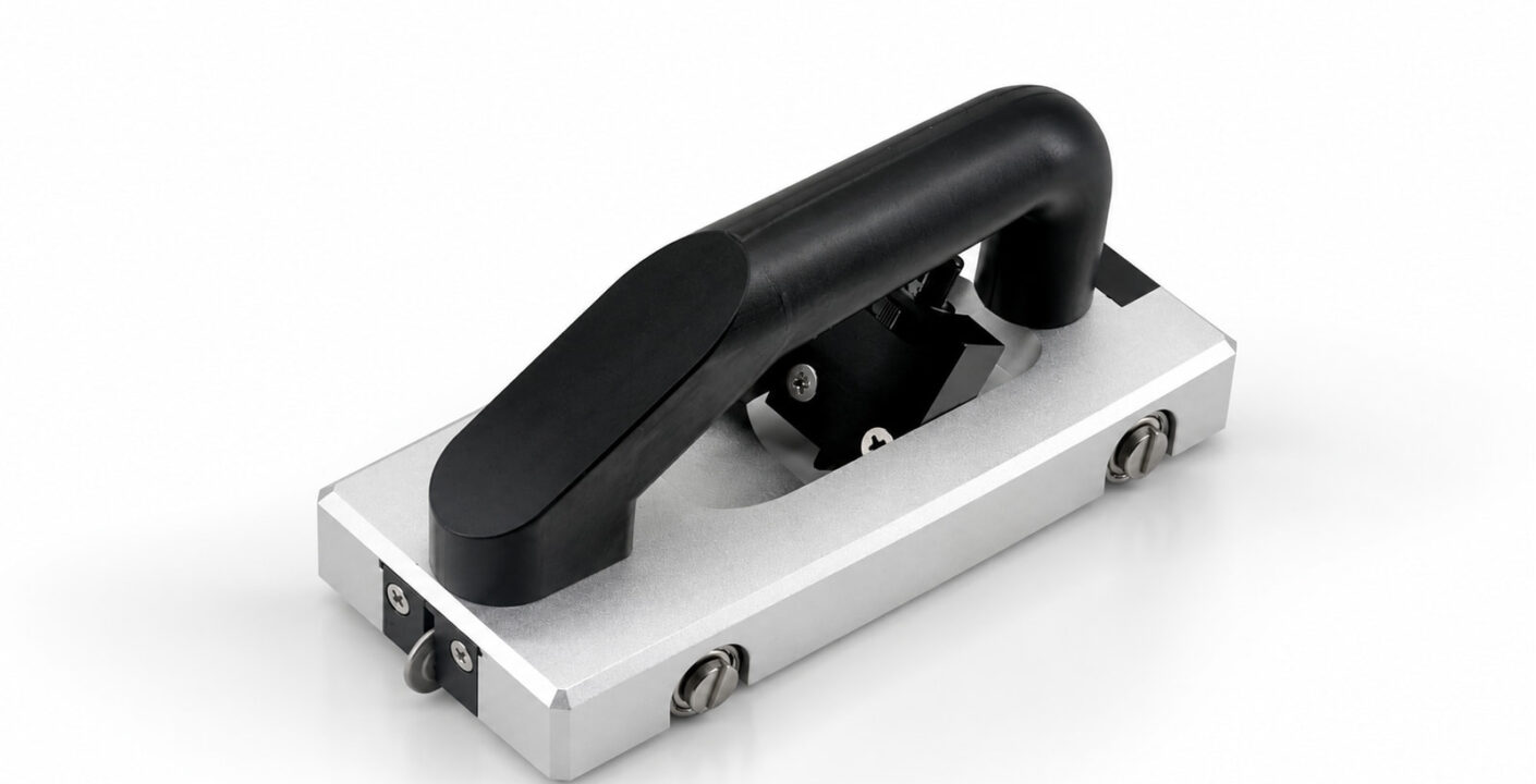Version 1.0 manual floor groover with a black top handle, silver frame and guide wheel.