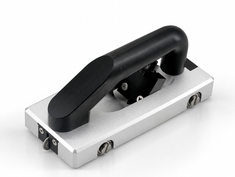 Version 1.0 manual floor groover with a black top handle, silver frame and guide wheel.